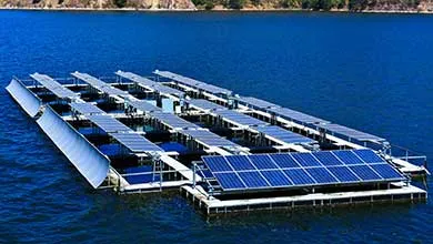 A large floating solar farm with rows of solar panels on a deep blue lake.