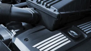 Stacked cross‑section diagram showing layered composite materials with embedded fibers.